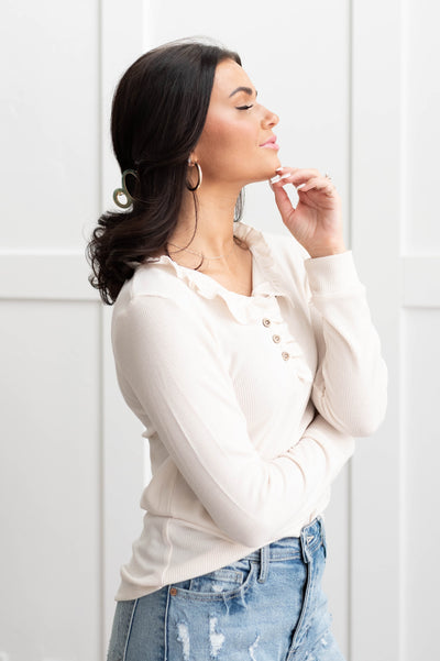 Side view of a cream knit top