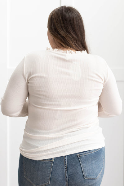 Back view of a plus size cream knit top