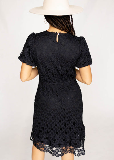 The back of a black lace dress