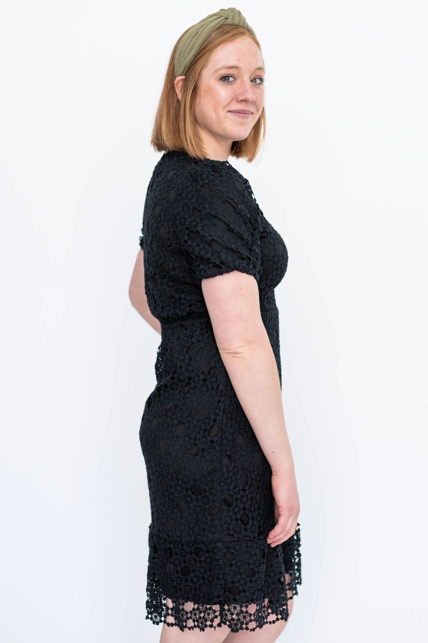 Side view of a short sleeve black lace dress