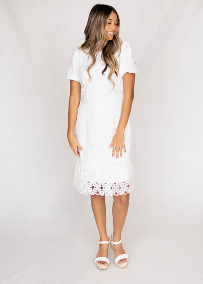 White lace dress that is knee length and with short sleeves