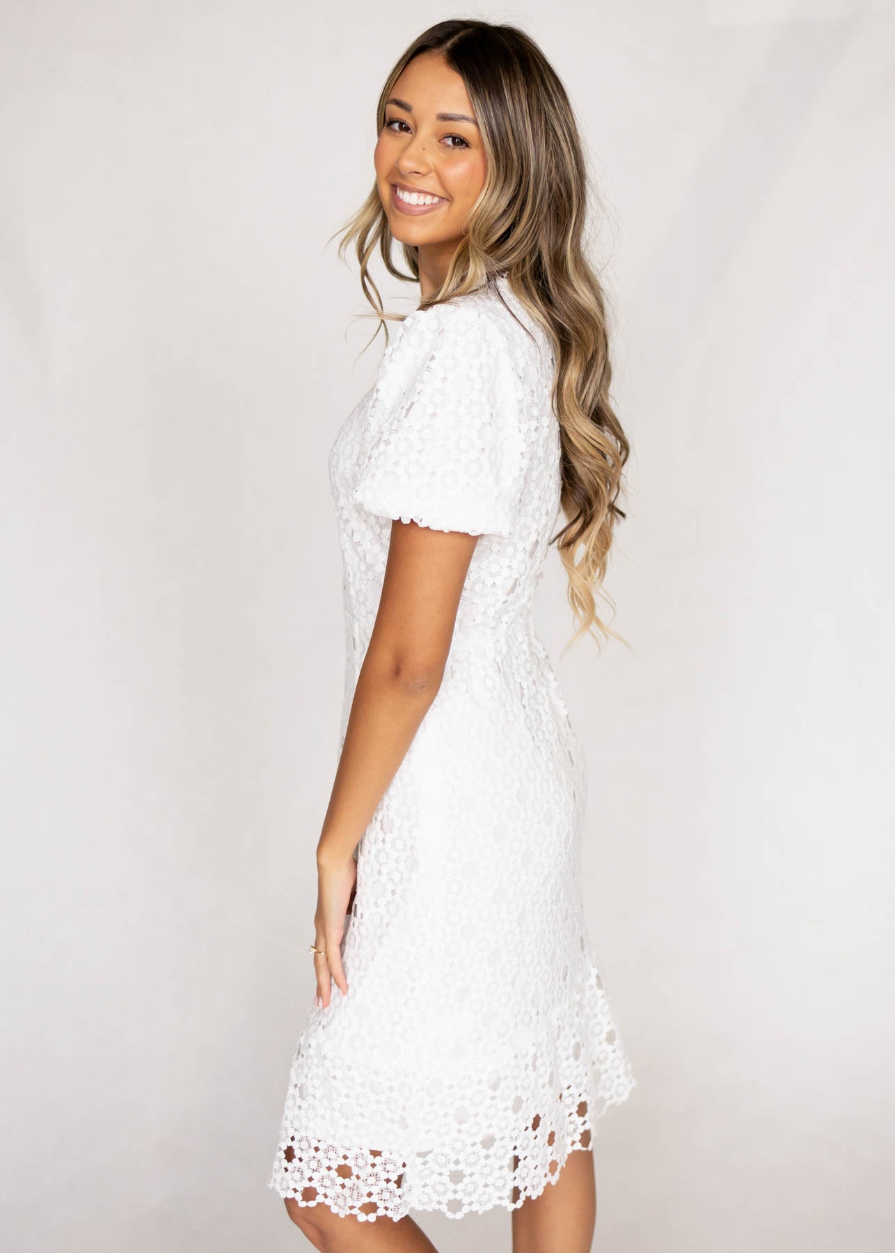 Side view of a short sleeve white lace dress