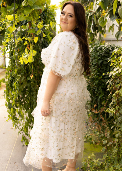 Side view of a plus size white floral dress