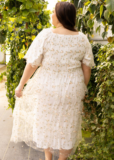 Back view of a plus size white floral dress