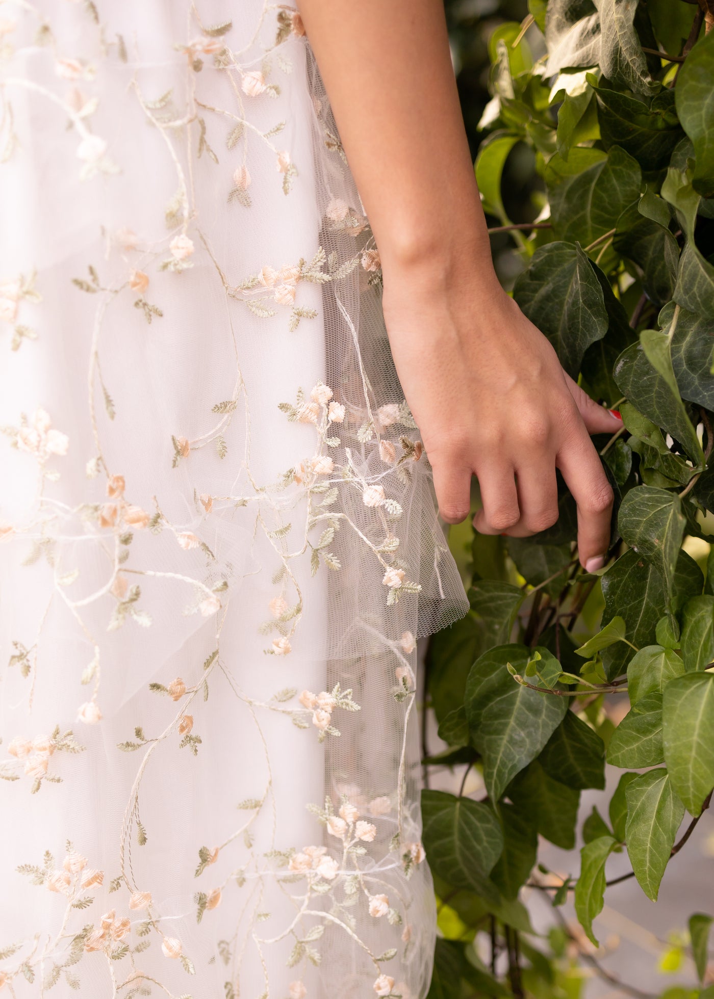 Close up of the fabric of a white floral dress
