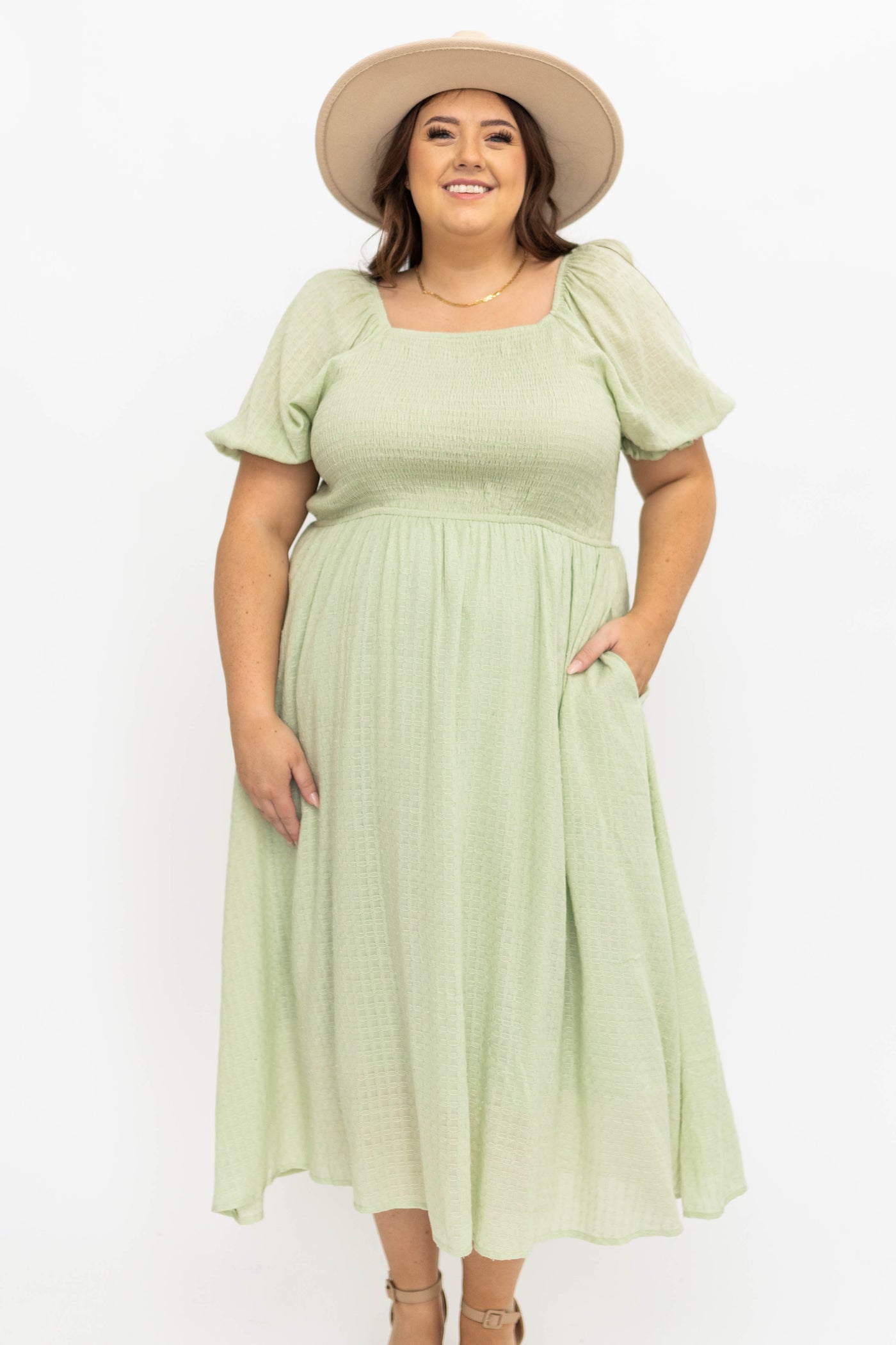 Front view of a light green plus size dress