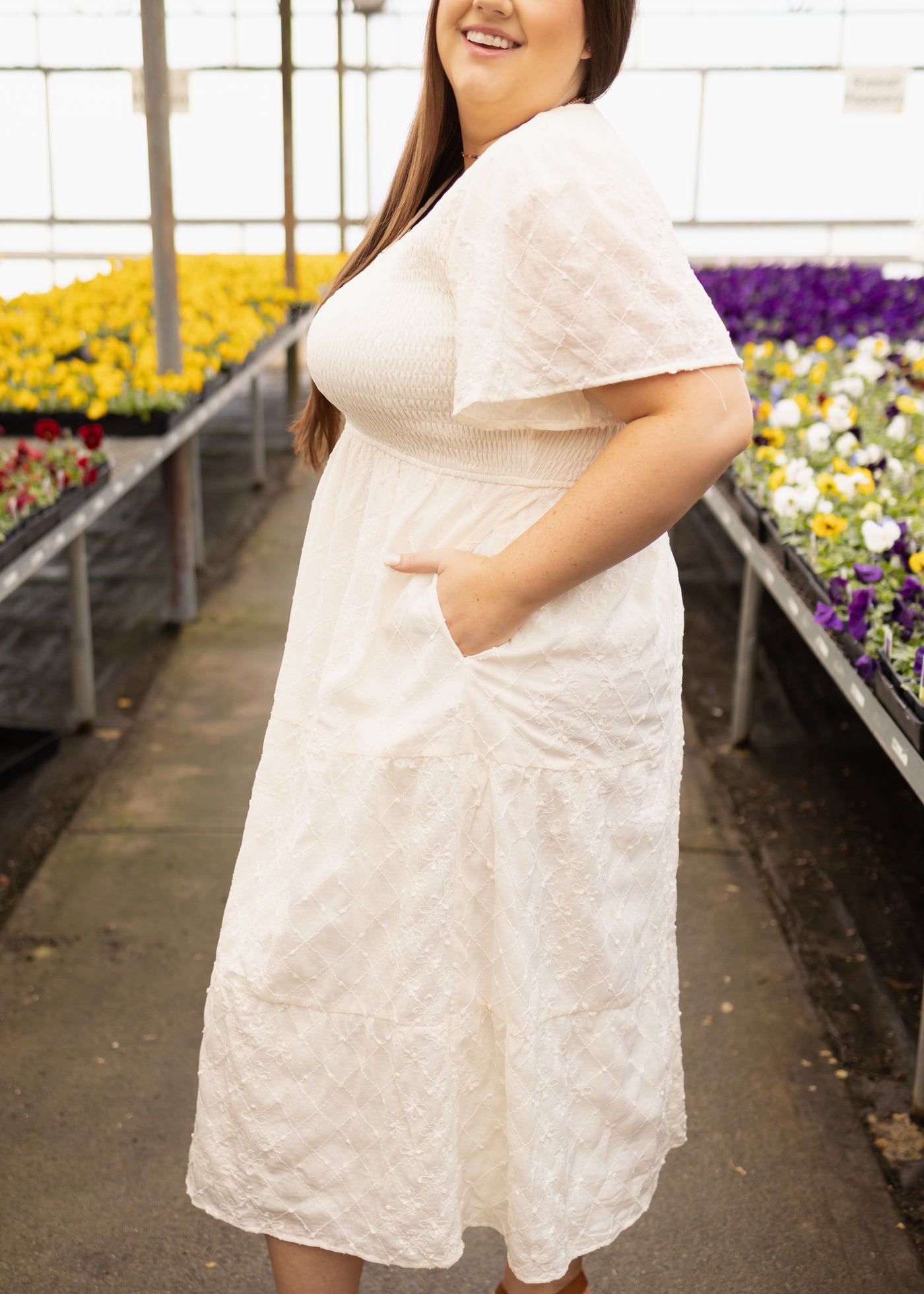 Side view of a plus size cream dress