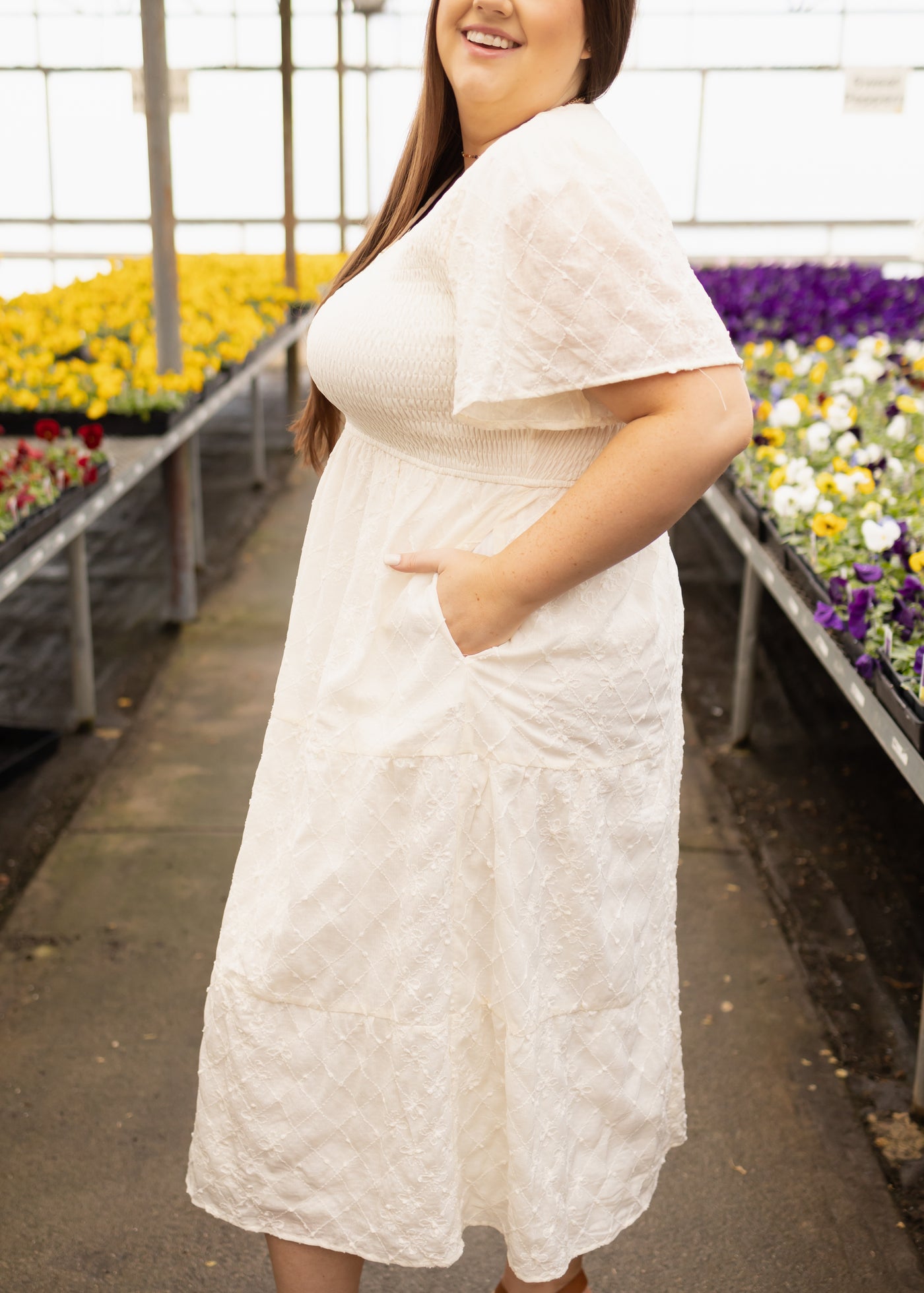 Side view of a plus size cream dress
