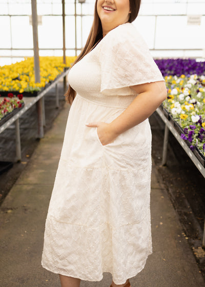 Side view of a plus size cream dress