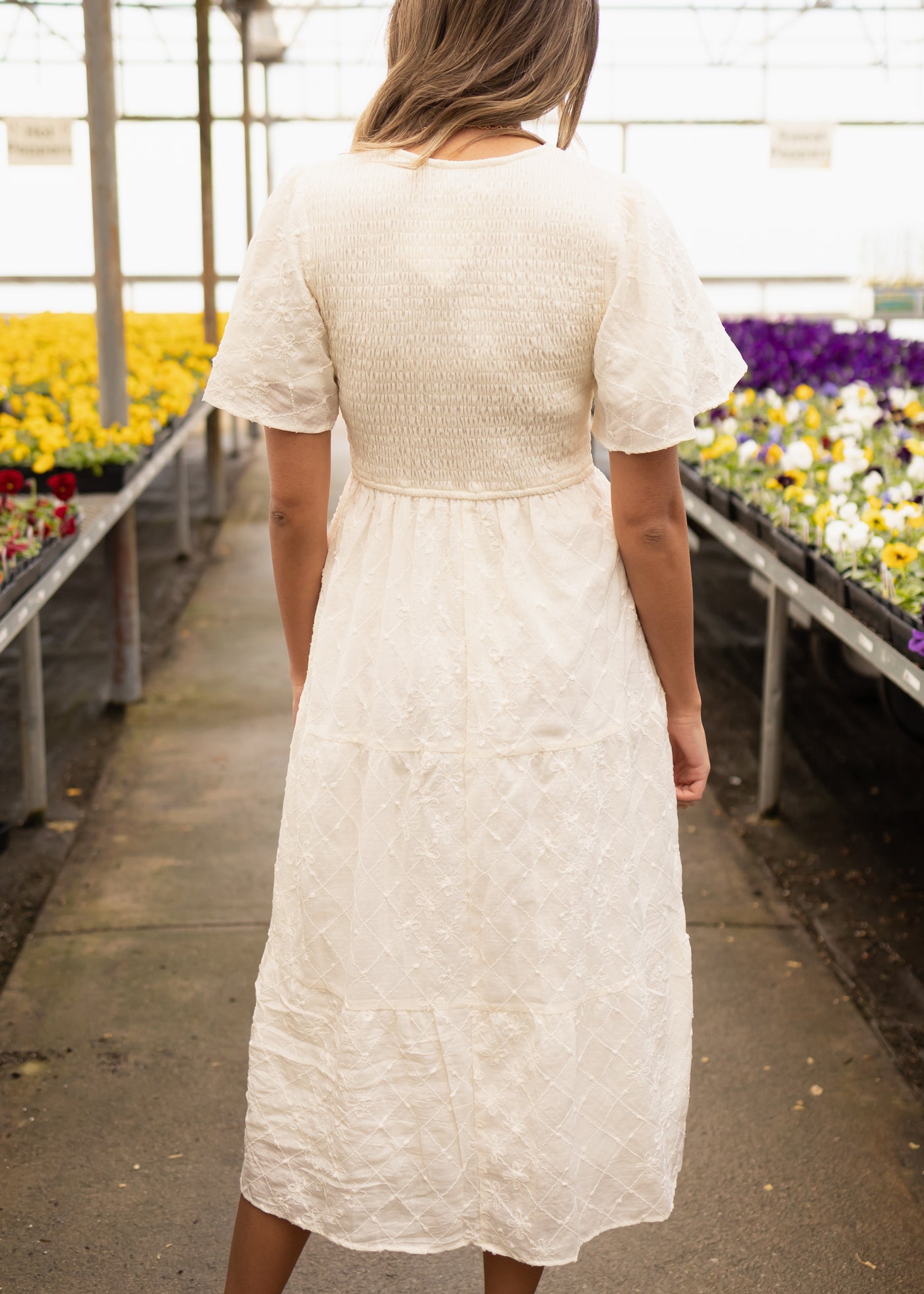 Back view of a short sleeve cream dress