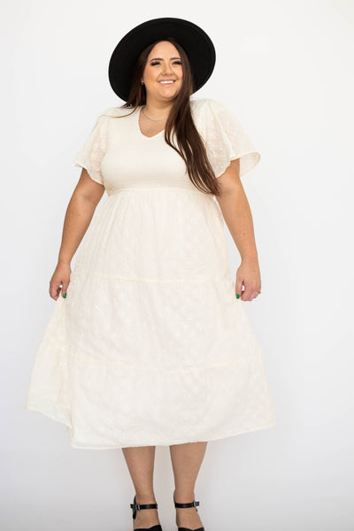 Plus size cream dress with short sleeves with smocked bodice