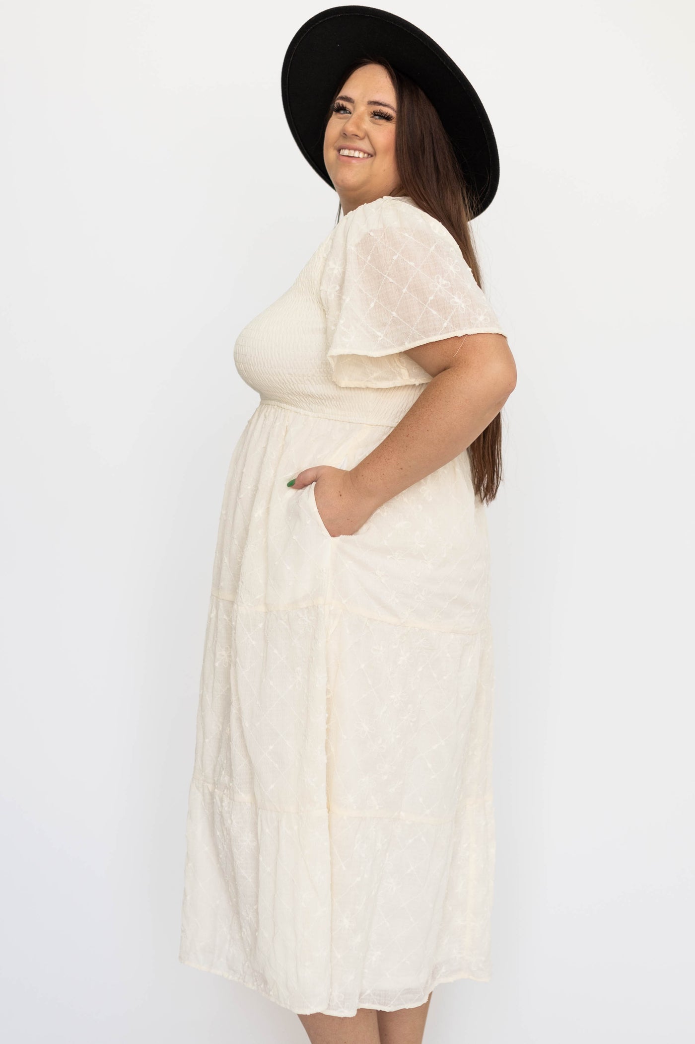Side view of a plus size cream dress