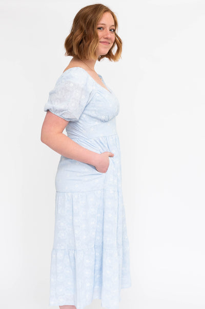 Side view of a light blue dress with pockets