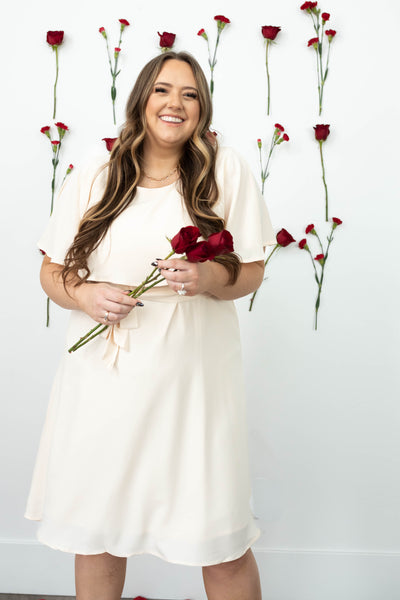 Short sleeve plus size cream dress with a tie at the waist
