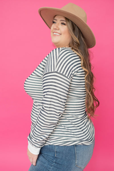Side view of a plus size navy striped top
