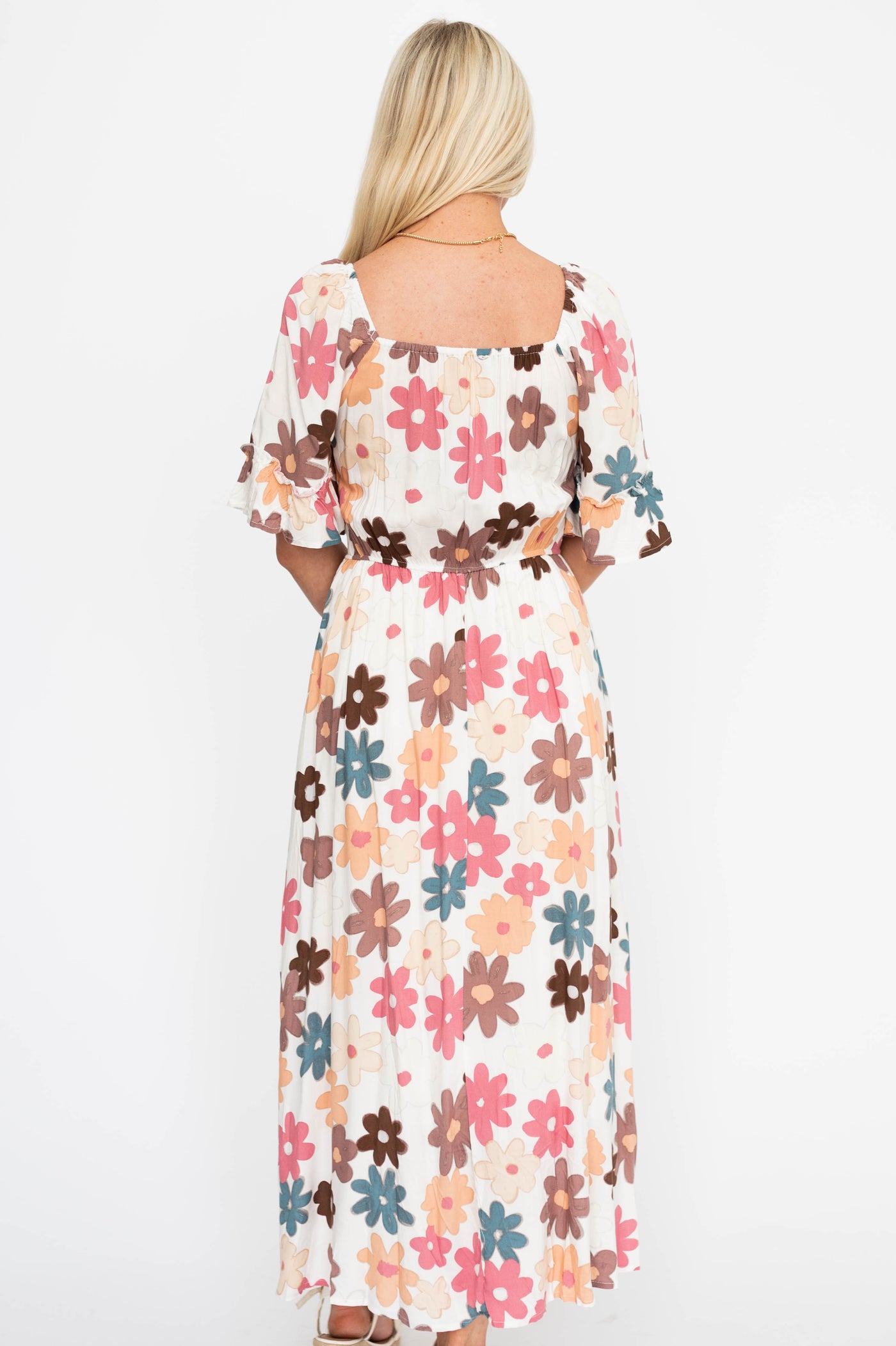 Back view of a cream floral dress