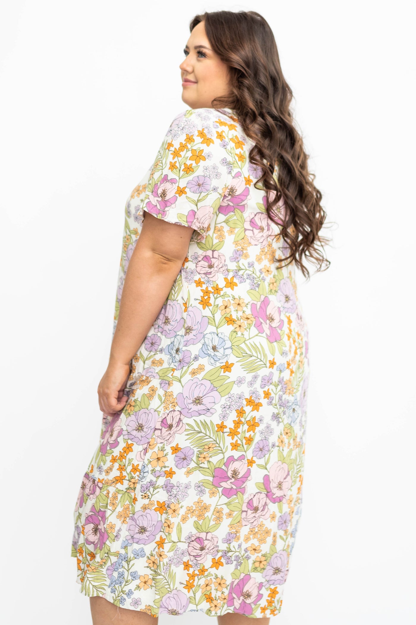 Side view of a plus size ivory floral dress