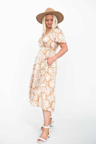 Side view of a taupe floral dress with pockets