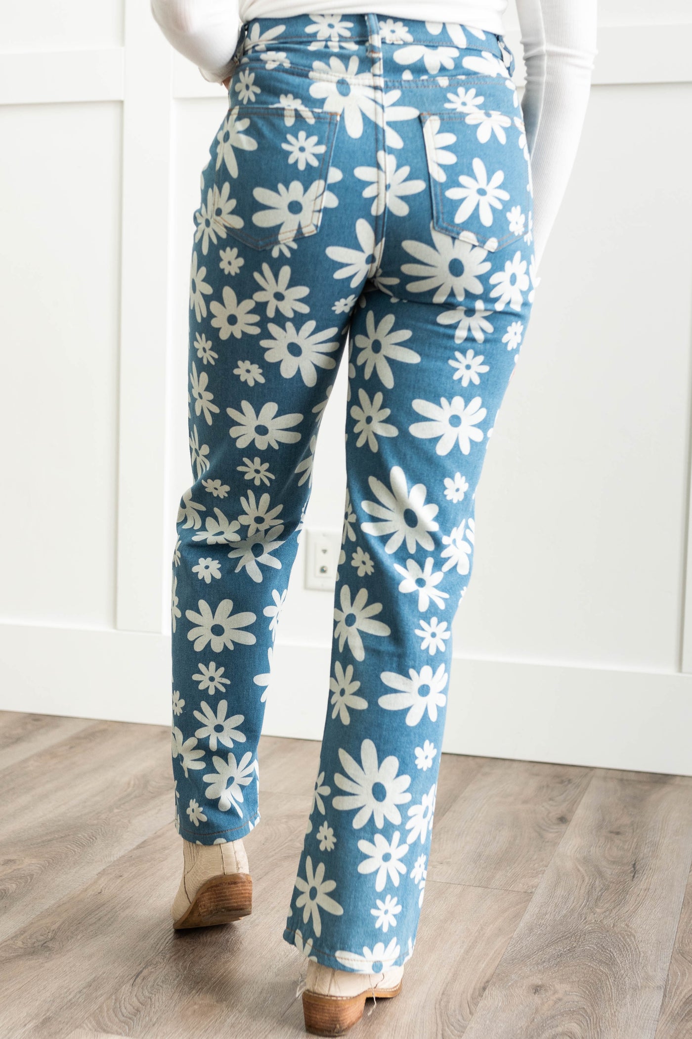 Back view of a blue pants with white daisies