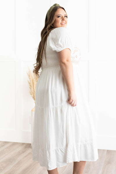 Side view of a plus size ivory dress
