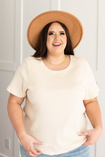 Front view of a plus size short sleeve cream top