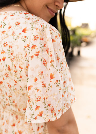 Sleeve of a cream floral dress