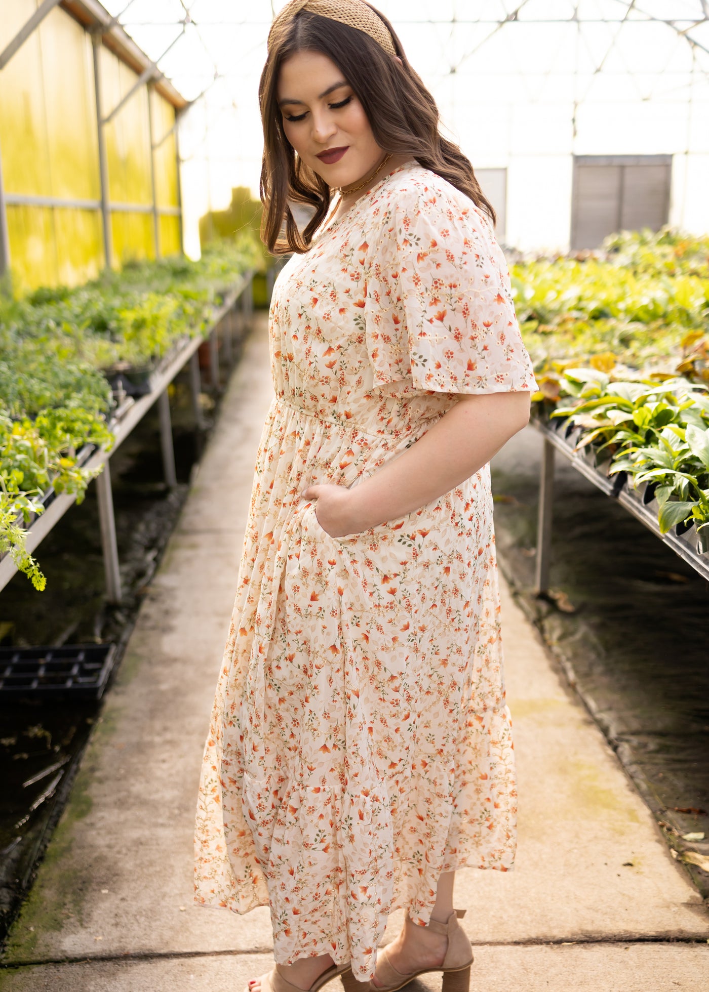 Side view of a plus size cream floral dress