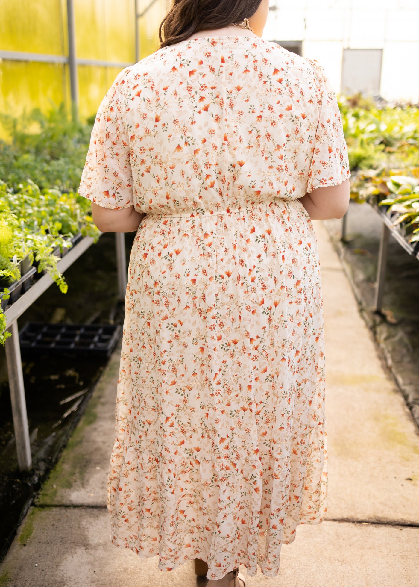 Back view of a plus size cream floral dress