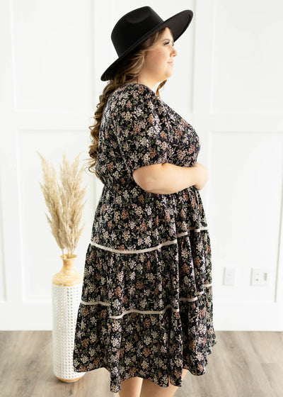 Side view of a plus size black floral dress