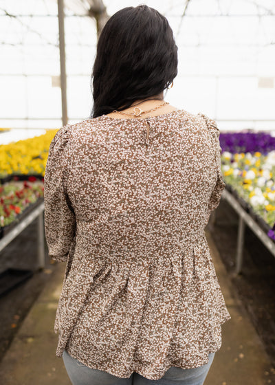 Back view of a brown floral top