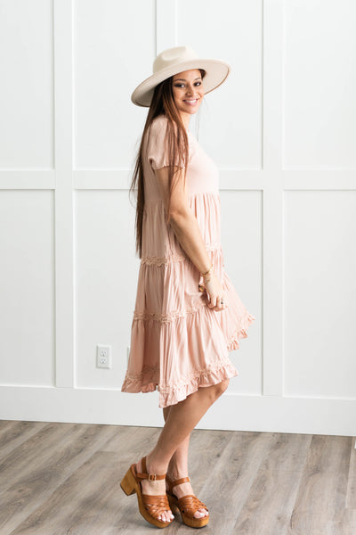 Side view of a short sleeve blush tiered dress