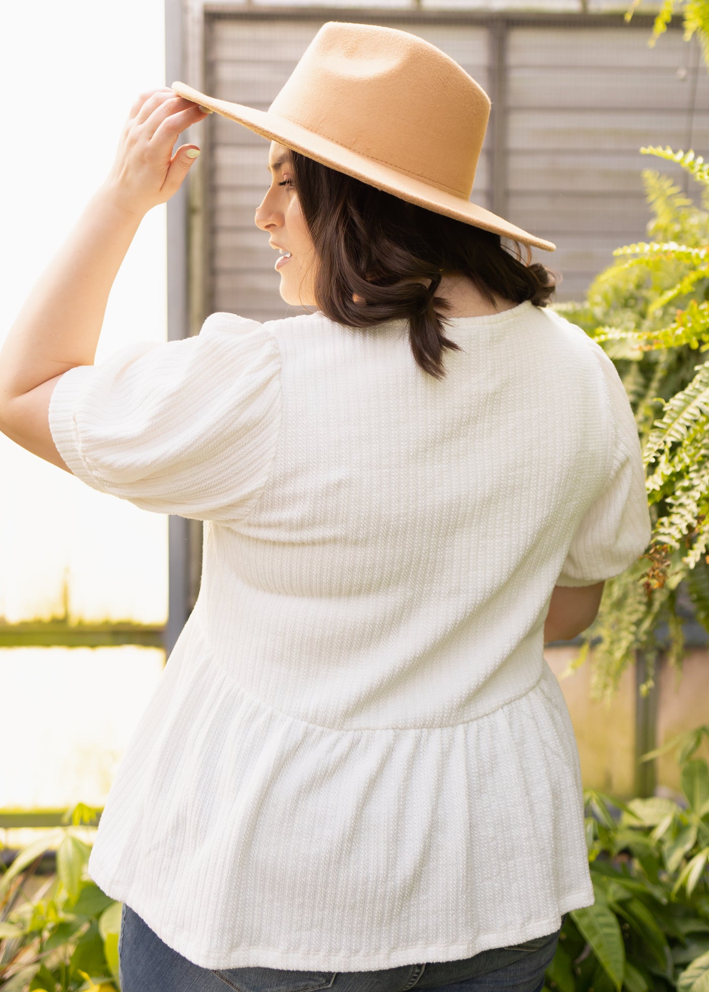 Back view of a plus size ivory top