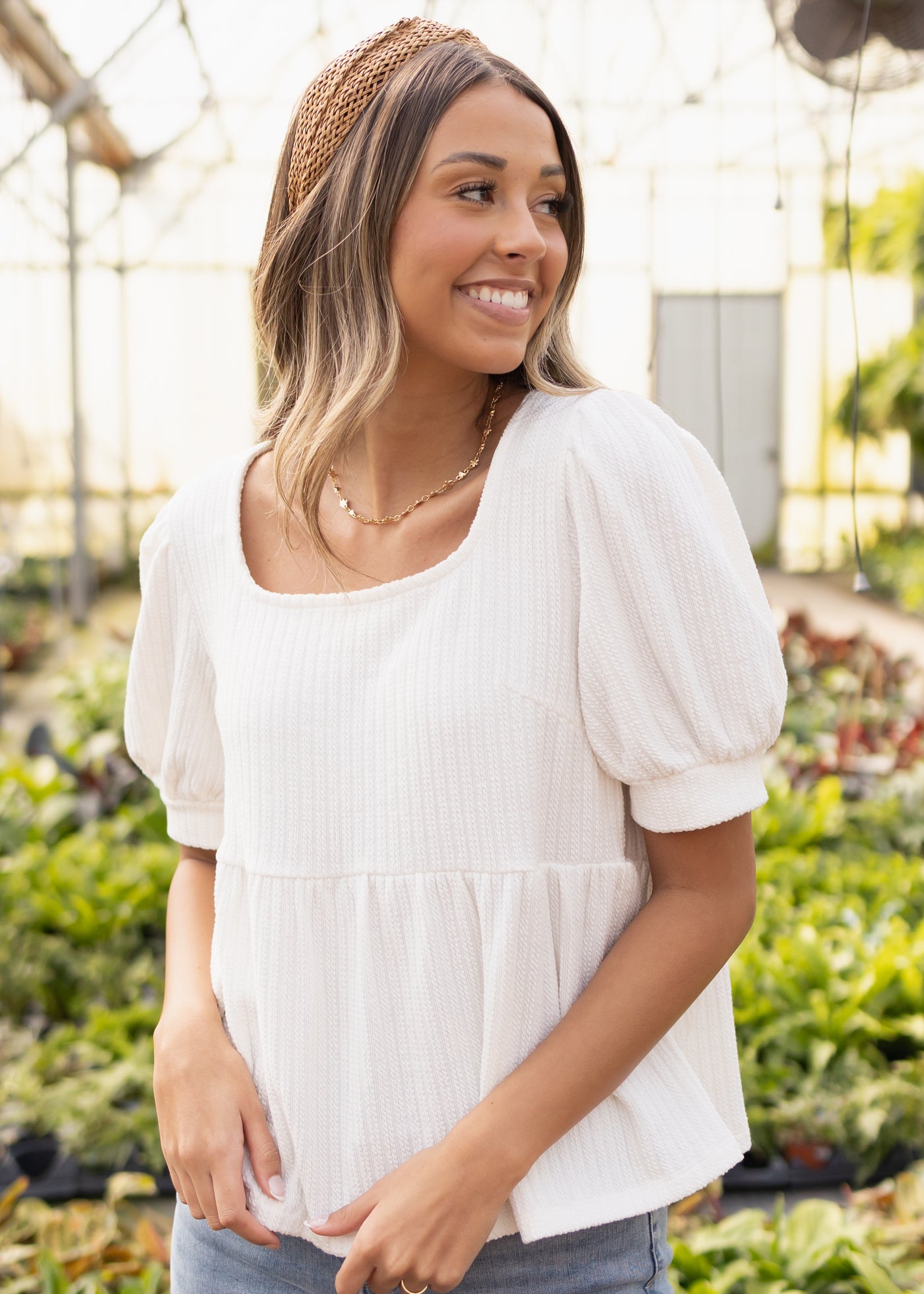 Short puff sleeves of an ivory top