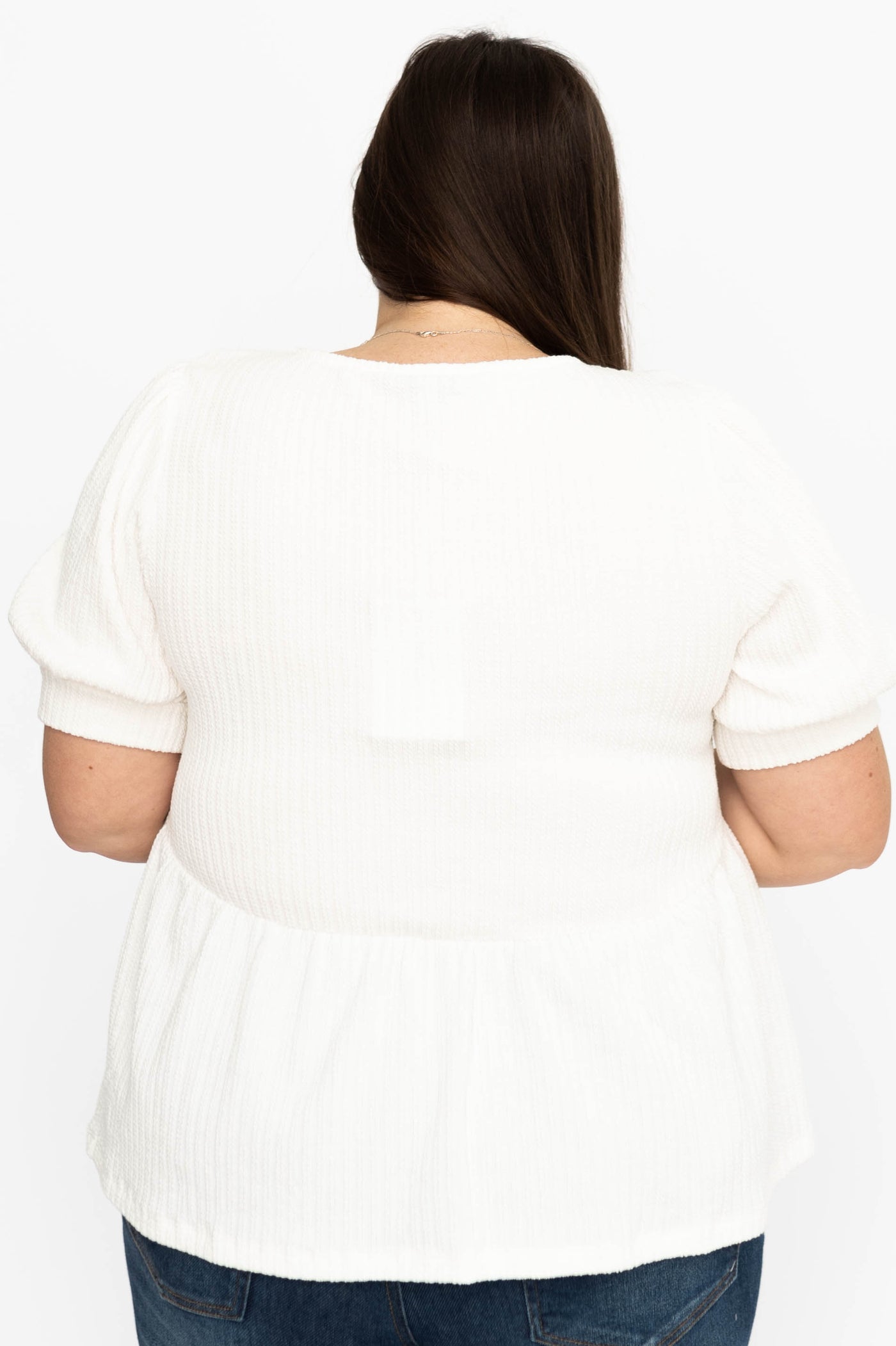 Back view of a plus size ivory top