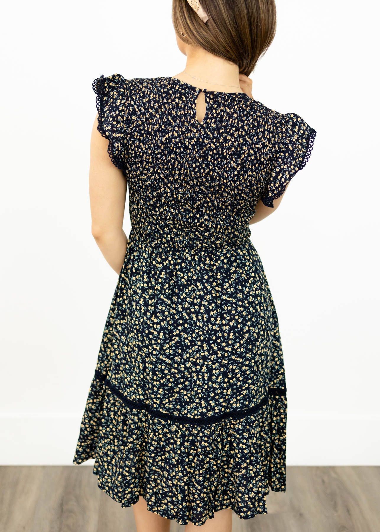 Back view of a navy floral dress