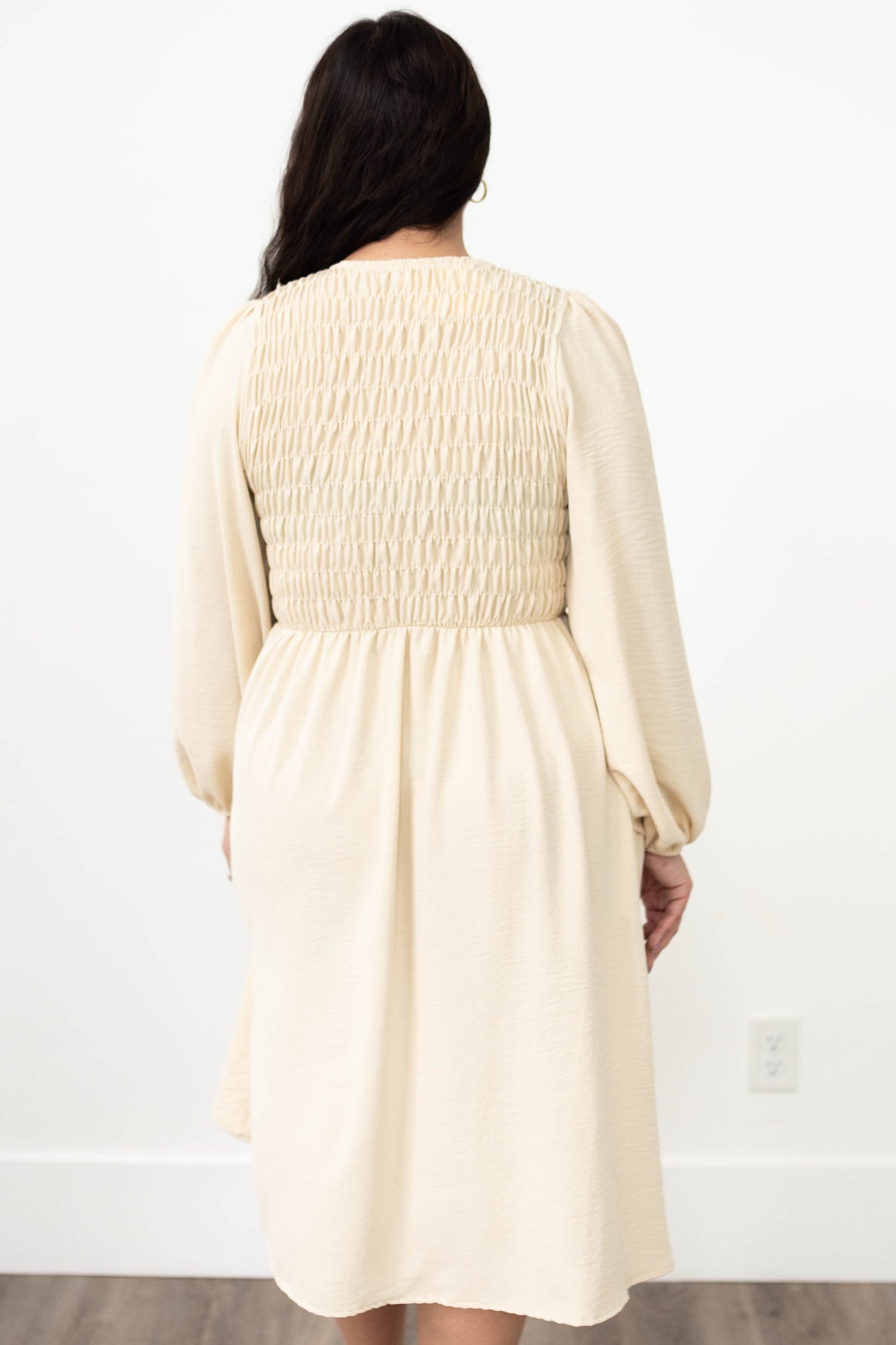 Back view of a cream lace dress