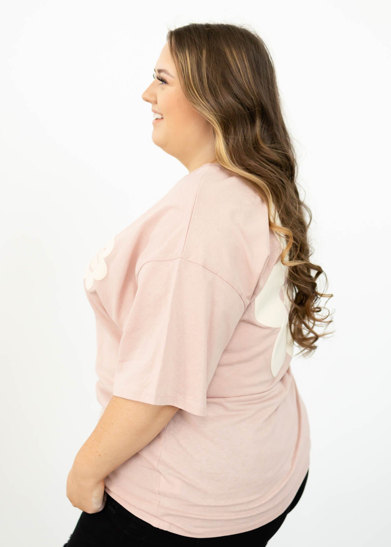 Side view of a plus size pink top