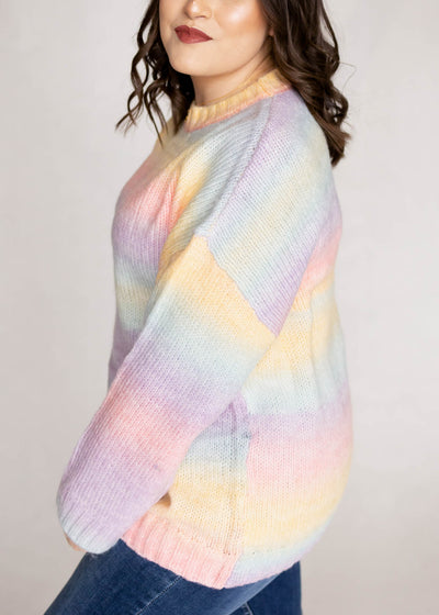 Side view of a plus size pastel sweater