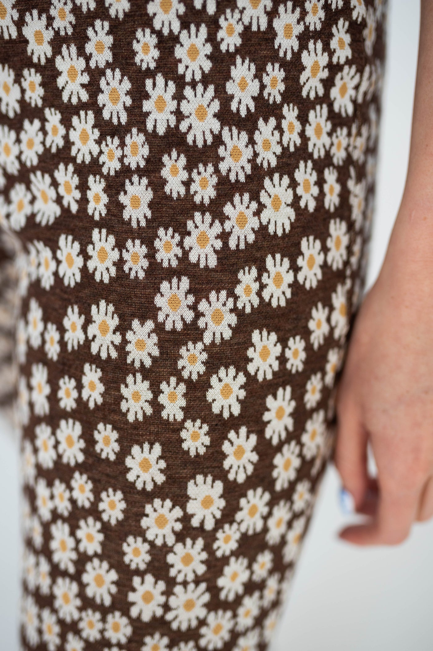 Brown floral pants with white daisies