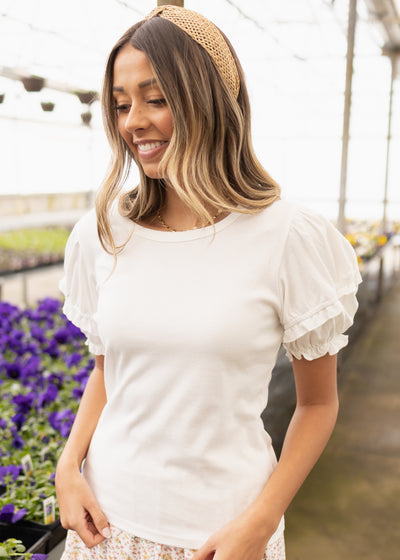 Small white top with ruffles on the short sleeves