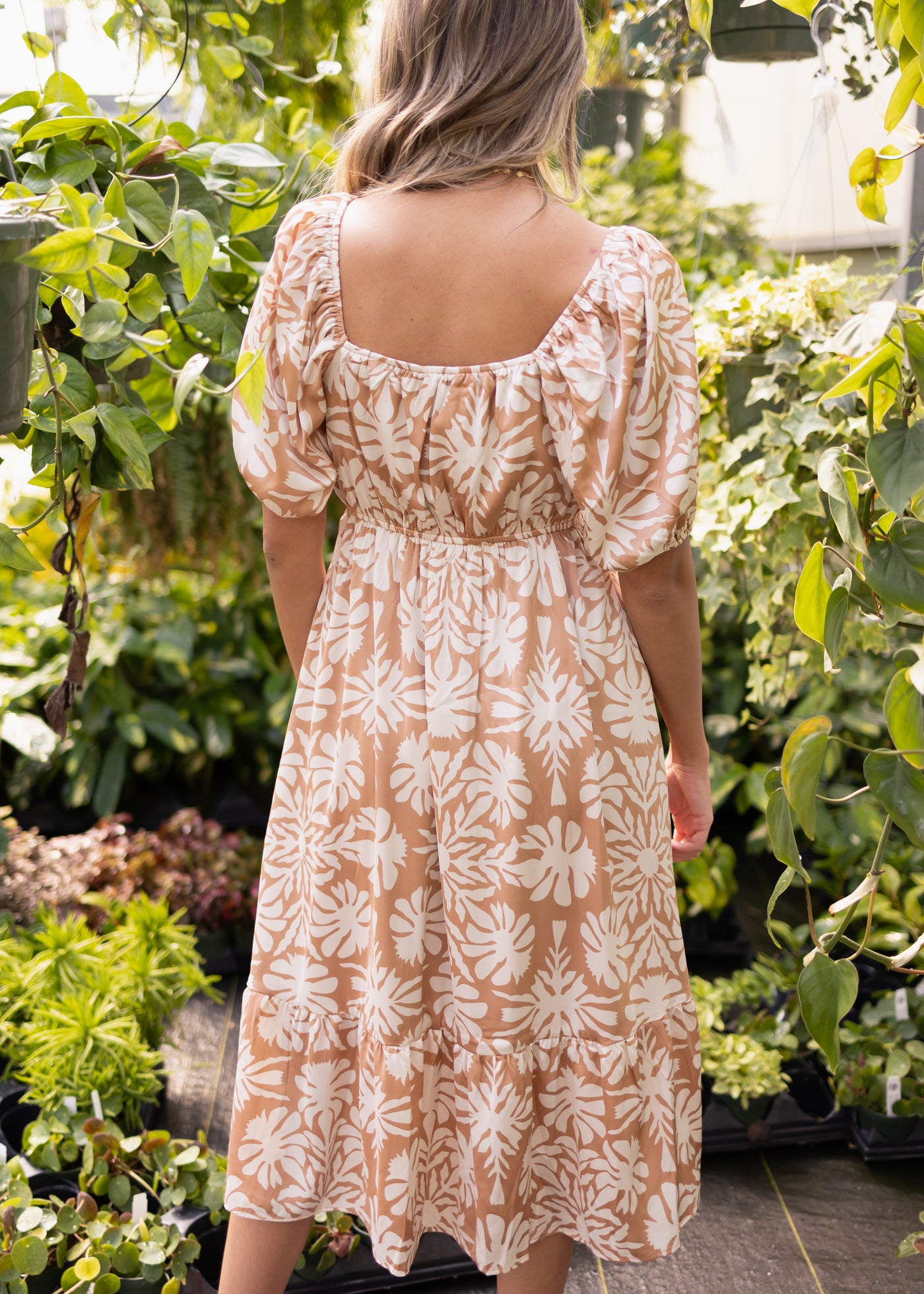 Back view of a short sleeve taupe floral dress