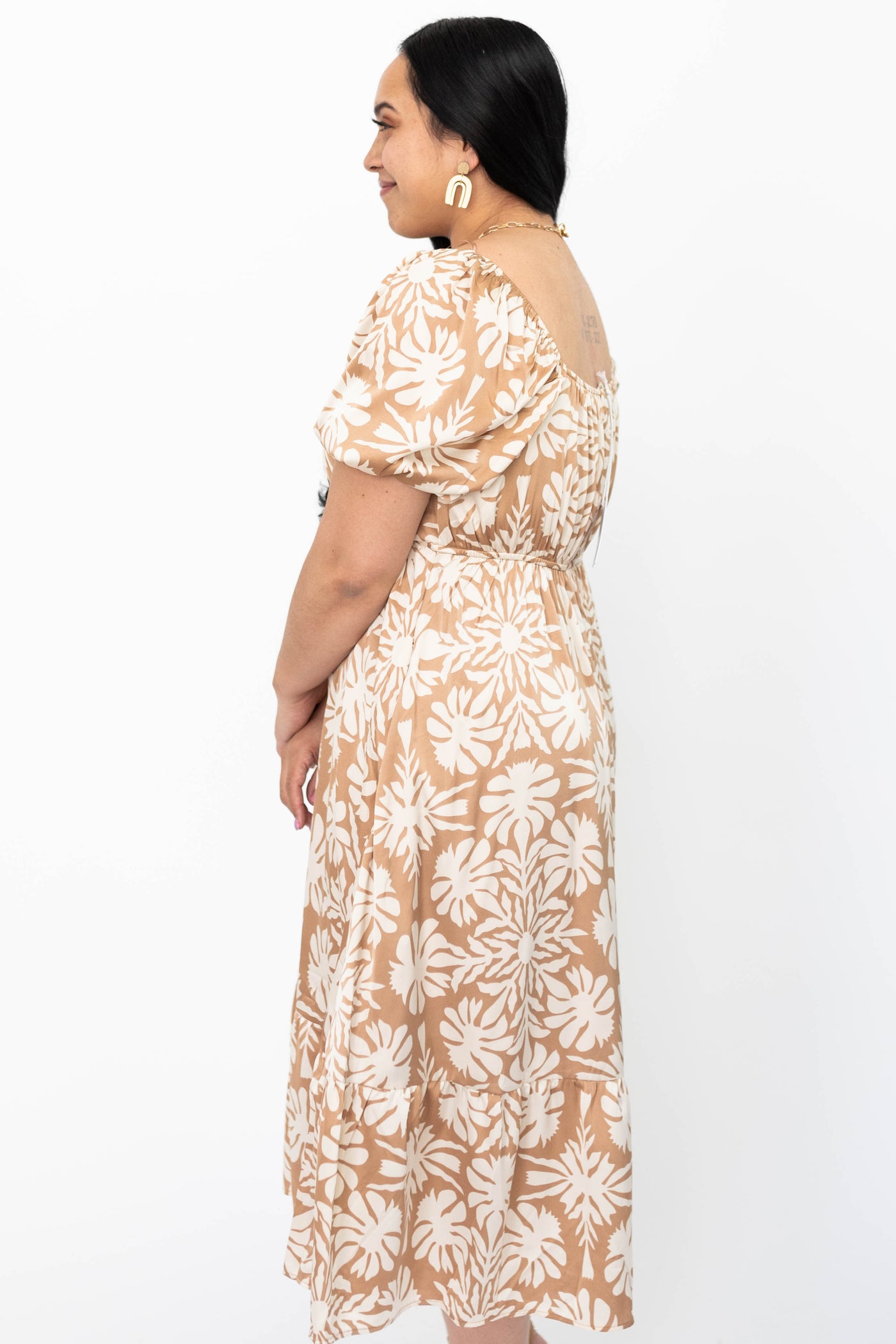 Side view of a large taupe floral dress