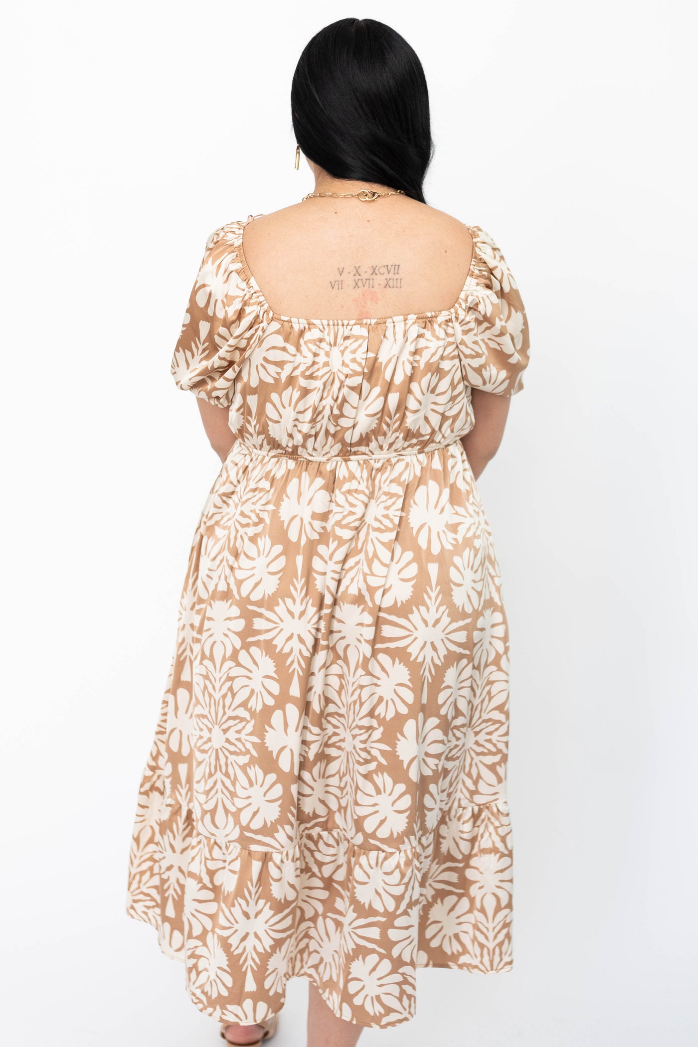 Back view of a large taupe floral dress
