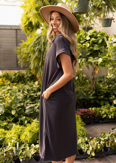 Side view of a short sleeve black dress with pocket