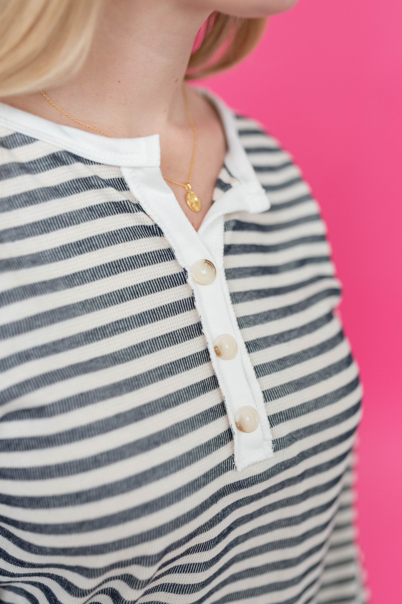 Button detail on a navy striped top