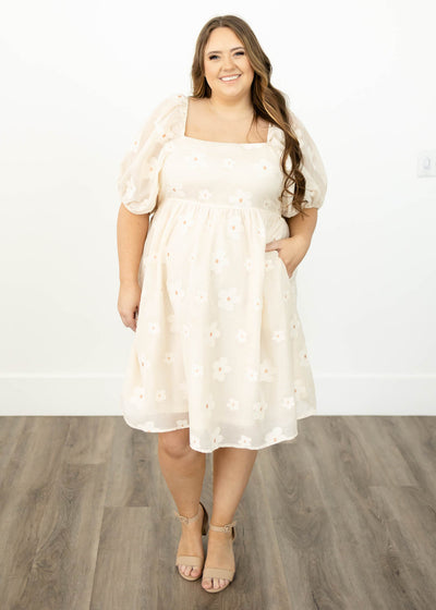 Short sleeve knee length cream floral dress with a square neck