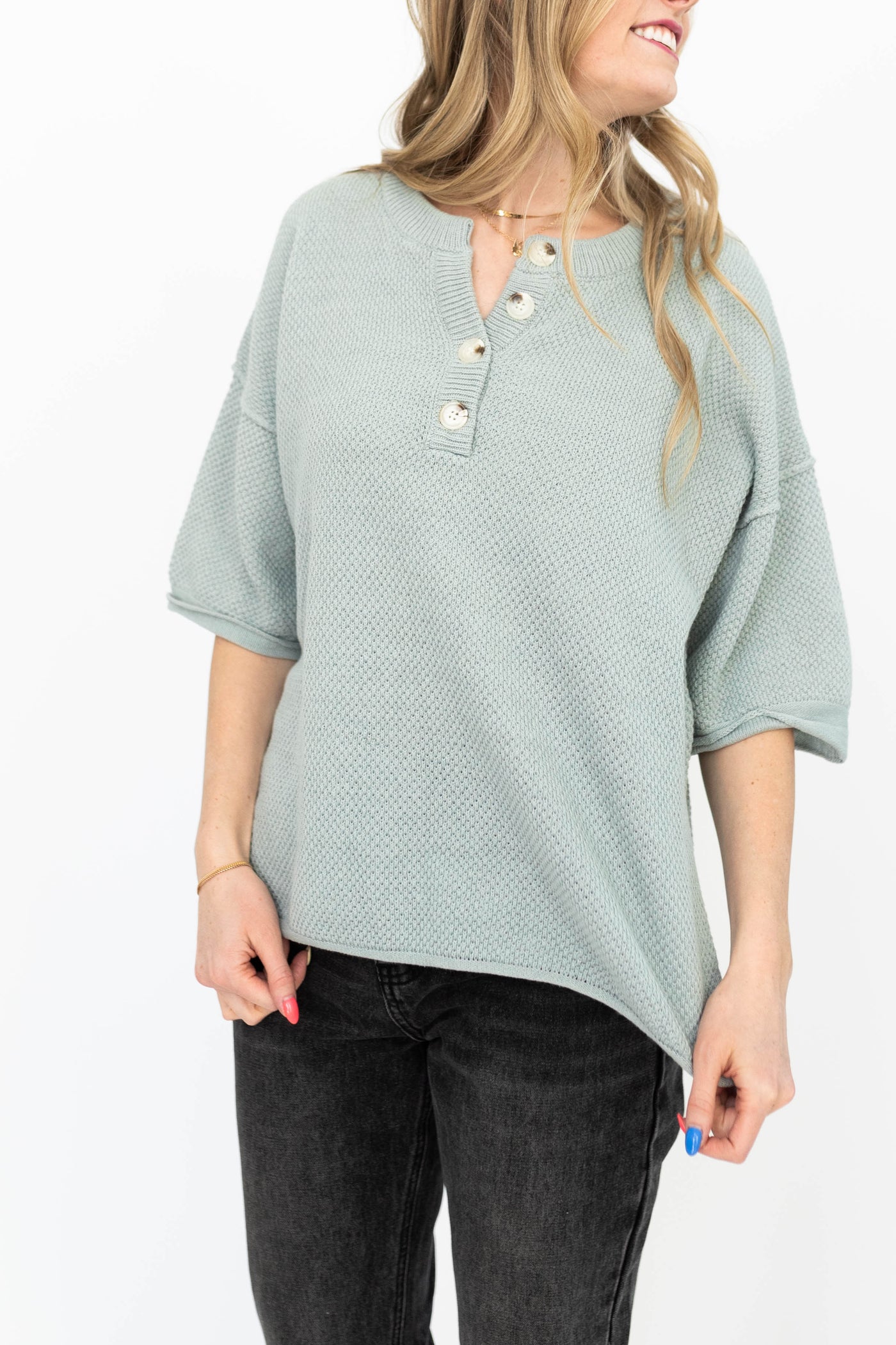 Dusty sage top with short sleeves and buttons at the neck