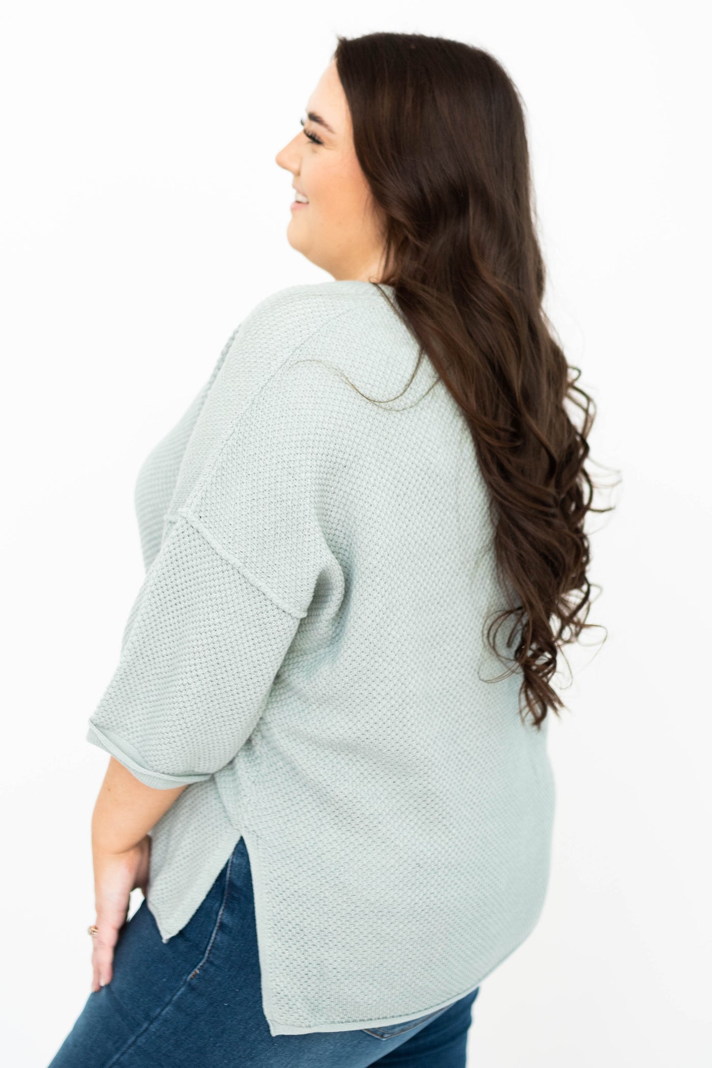 Side view of a plus size dusty sage top