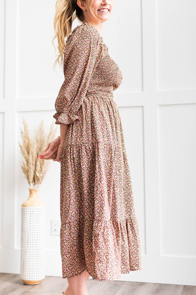 Side view of a black floral dress with a smocked bodice