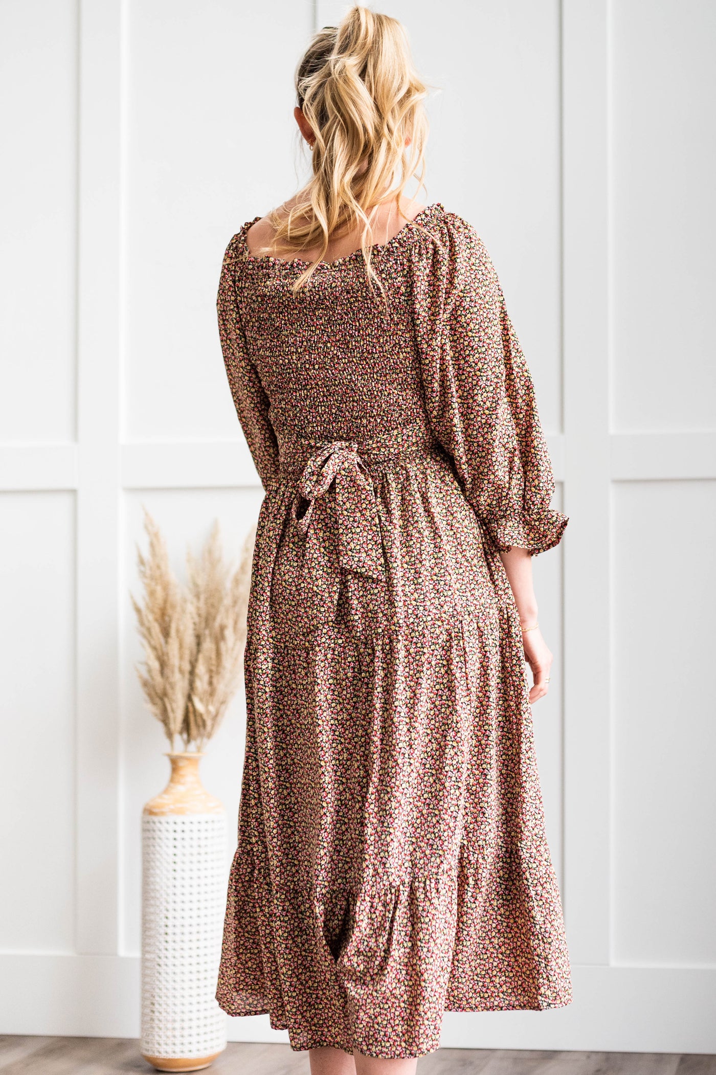 Back view of a black floral dress that ties in the back